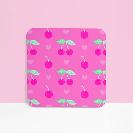 Sprinkle Club - A single pink square drinks coaster with a playful pattern of cherries and hearts