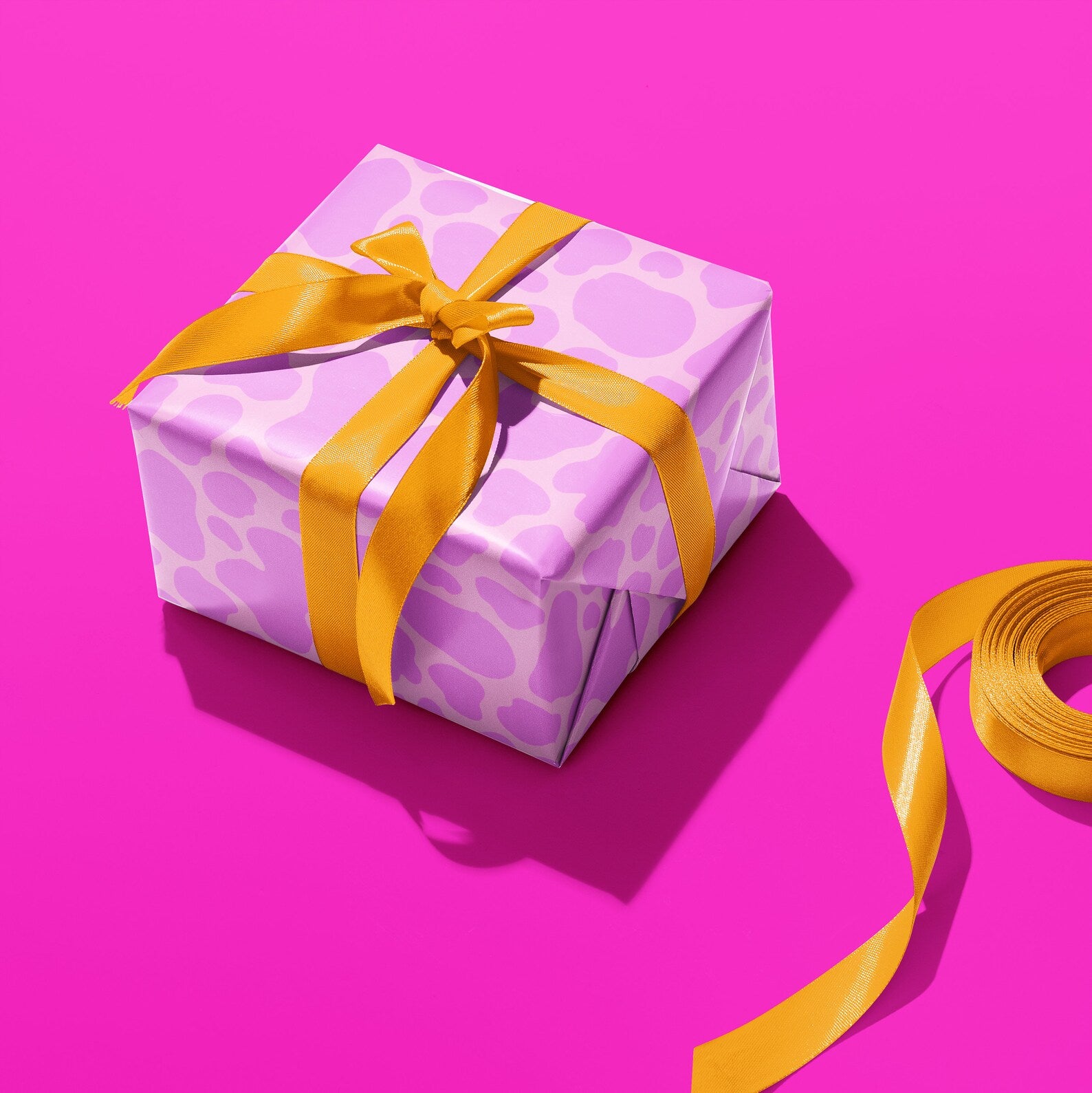 Sprinkle Club - A gift wrapped in lilac cow print wrapping paper