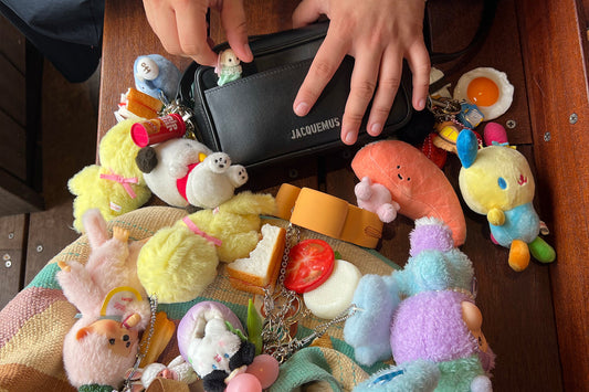 An assortment of plushie bag charms on a black bag