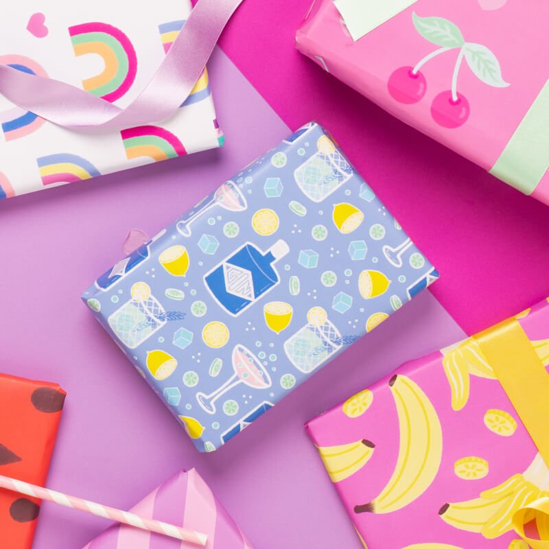 Sprinkle Club - Gift wrapped in blue wrapping paper with a pattern of gin and prosecco cocktails