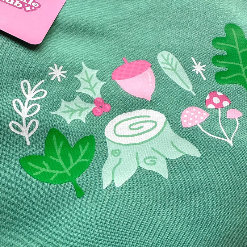 Sprinkle Club - A cute pink and green forest woodland design on a green sweatshirt