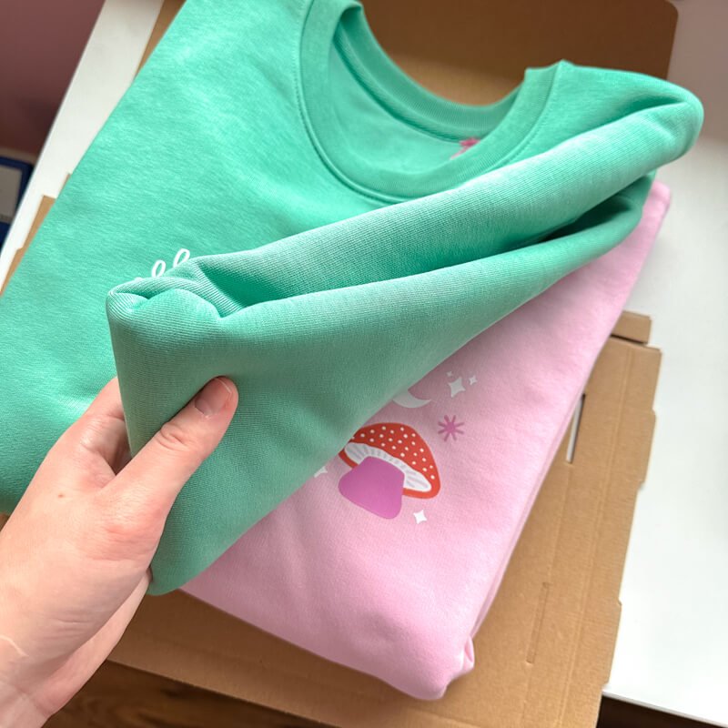 Sprinkle Club - A collection of two forest green and pink sweatshirts with witch inspired designs
