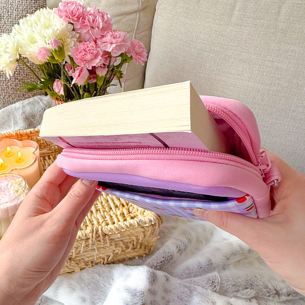 Sprinkle Club - Paperback book inside a pink padded book sleeve with cherry gingham front pocket
