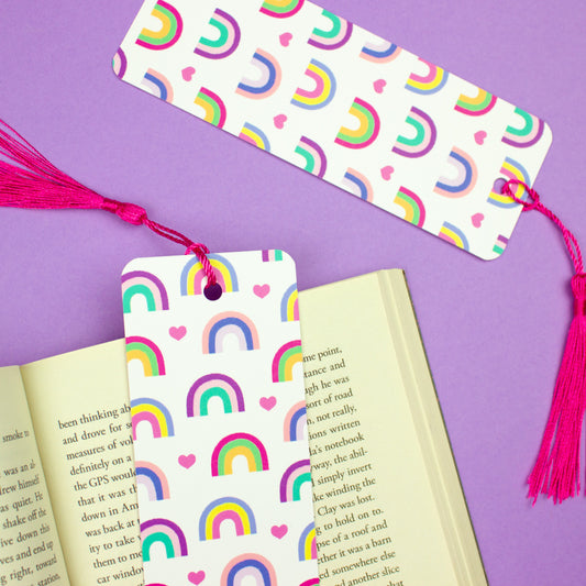 Sprinkle Club - A bookmark with a rainbow and heart pattern, featuring a pink tassel