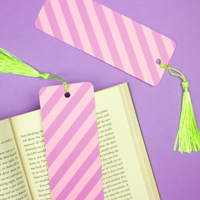 Sprinkle Club - A bookmark with pink and purple diagonal candy stripes and a bright green tassel