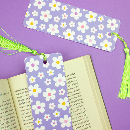 Sprinkle Club - A pastel lilac bookmark with a white and yellow daisy pattern and a green tassel