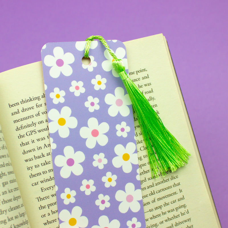 Sprinkle Club - A pastel lilac bookmark with a white and yellow daisy pattern and a green tassel