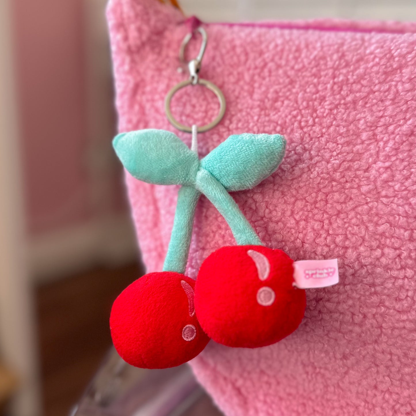 Cute cherry keychain with soft plush texture, embroidered features, and silver keyring – kawaii aesthetic accessory from Sprinkle Club