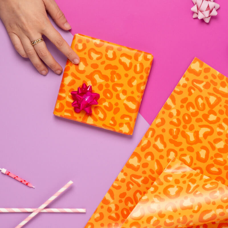 Sprinkle Club - A wrapped gift and a sheet of orange leopard print wrapping paper