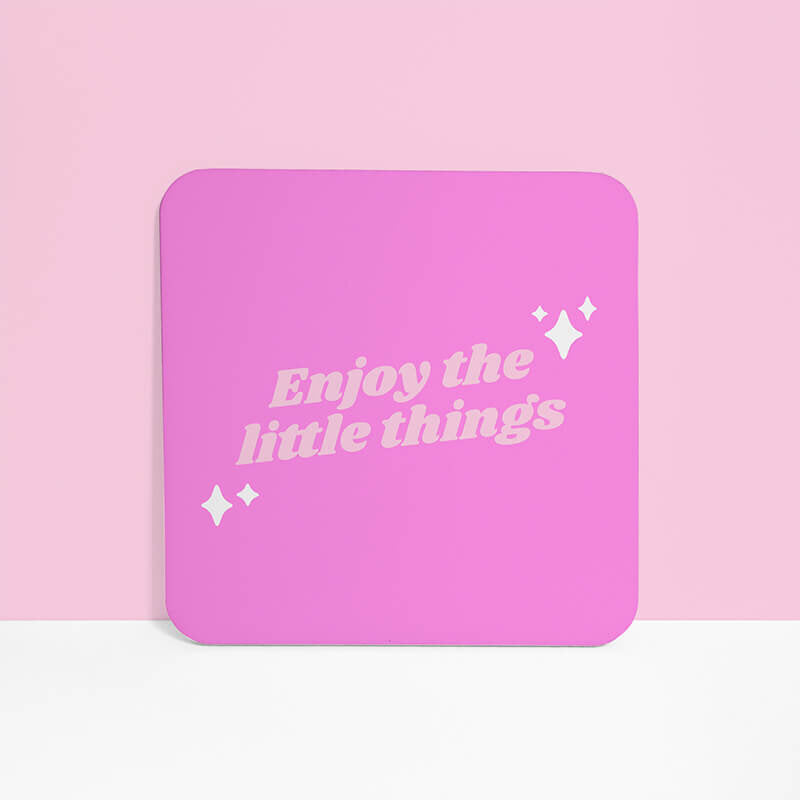 Sprinkle Club - Single vibrant pink square coaster with 'Enjoy the little things' in playful light pink lettering on a soft pink background