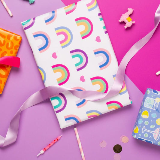 Sprinkle Club - A present wrapped in cute wrapping paper with rainbows and hearts