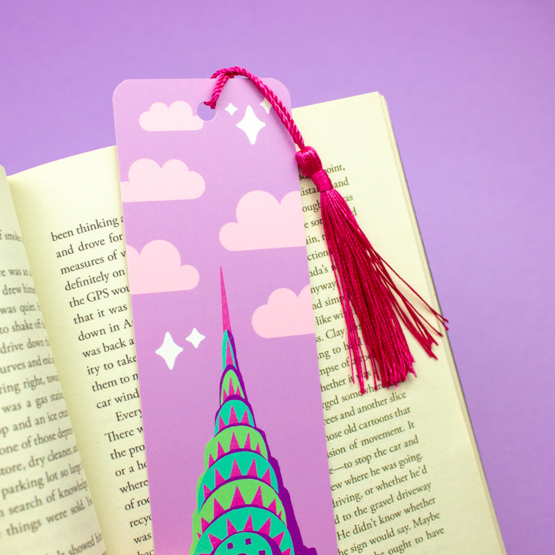 Sprinkle Club - A purple bookmark with a graphic of the Chrysler Building and clouds, finished with a bright pink tassel