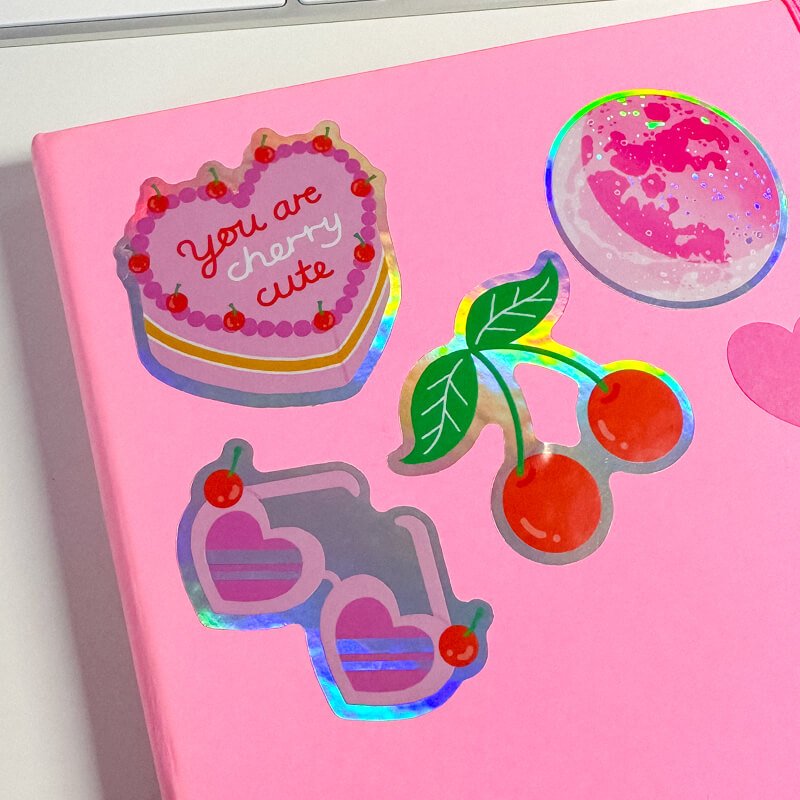 Sprinkle Club - Pink heart shaped vintage cake sticker decorating a notebook