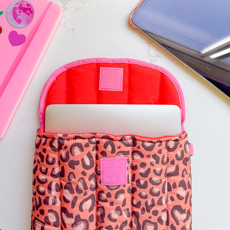 Sprinkle Club - Leopard print quilted laptop sleeve with bright red and pink lining and a laptop inside