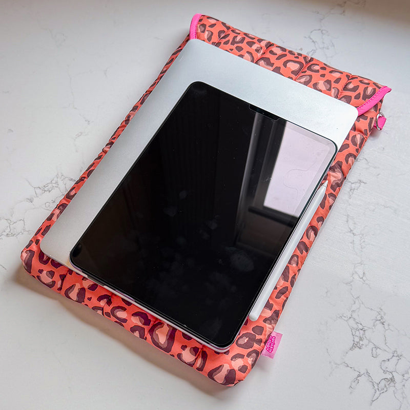 Sprinkle Club - Leopard print quilted laptop sleeve shown with a laptop and tablet iPad on a marble desk