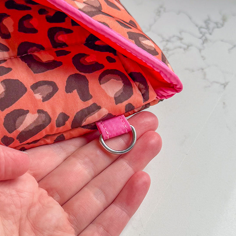 Sprinkle Club - Close-up of the metal accessory loop on a leopard print quilted laptop sleeve