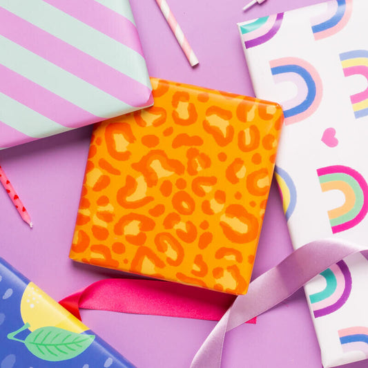 Sprinkle Club - A gift wrapped in bright orange leopard print wrapping paper