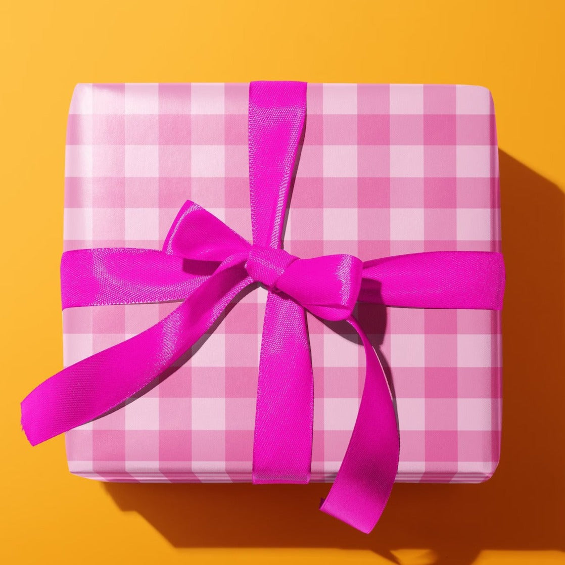 Sprinkle Club - A gift wrapped in a pink bow and wrapped in pink gingham print wrapping paper