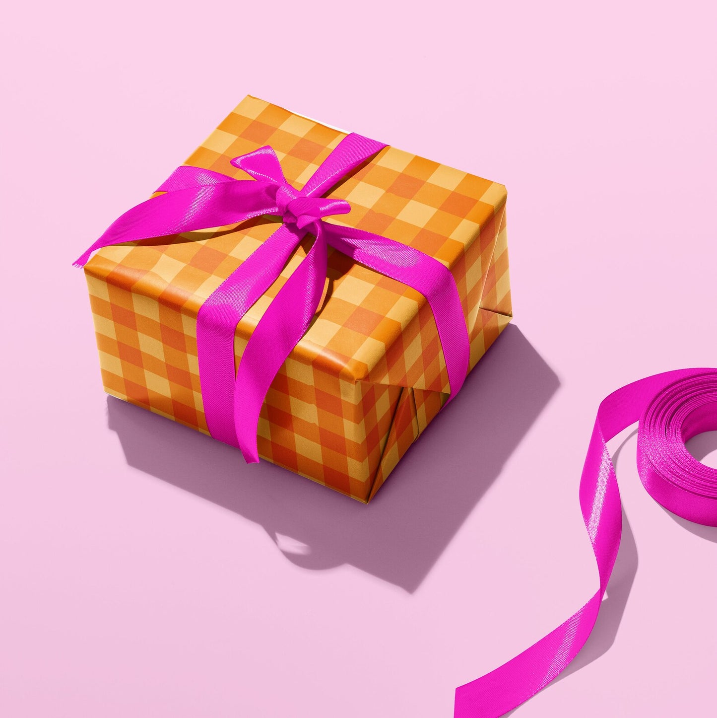 Sprinkle Club - A wrapped gift in gingham pattern wrapping paper and a pink bow