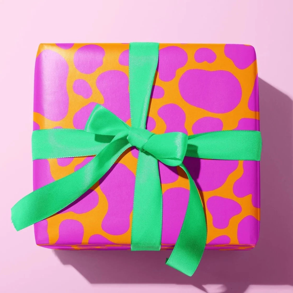 Sprinkle Club - A gift wrapped in funky orange and purple cow print wrapping paper