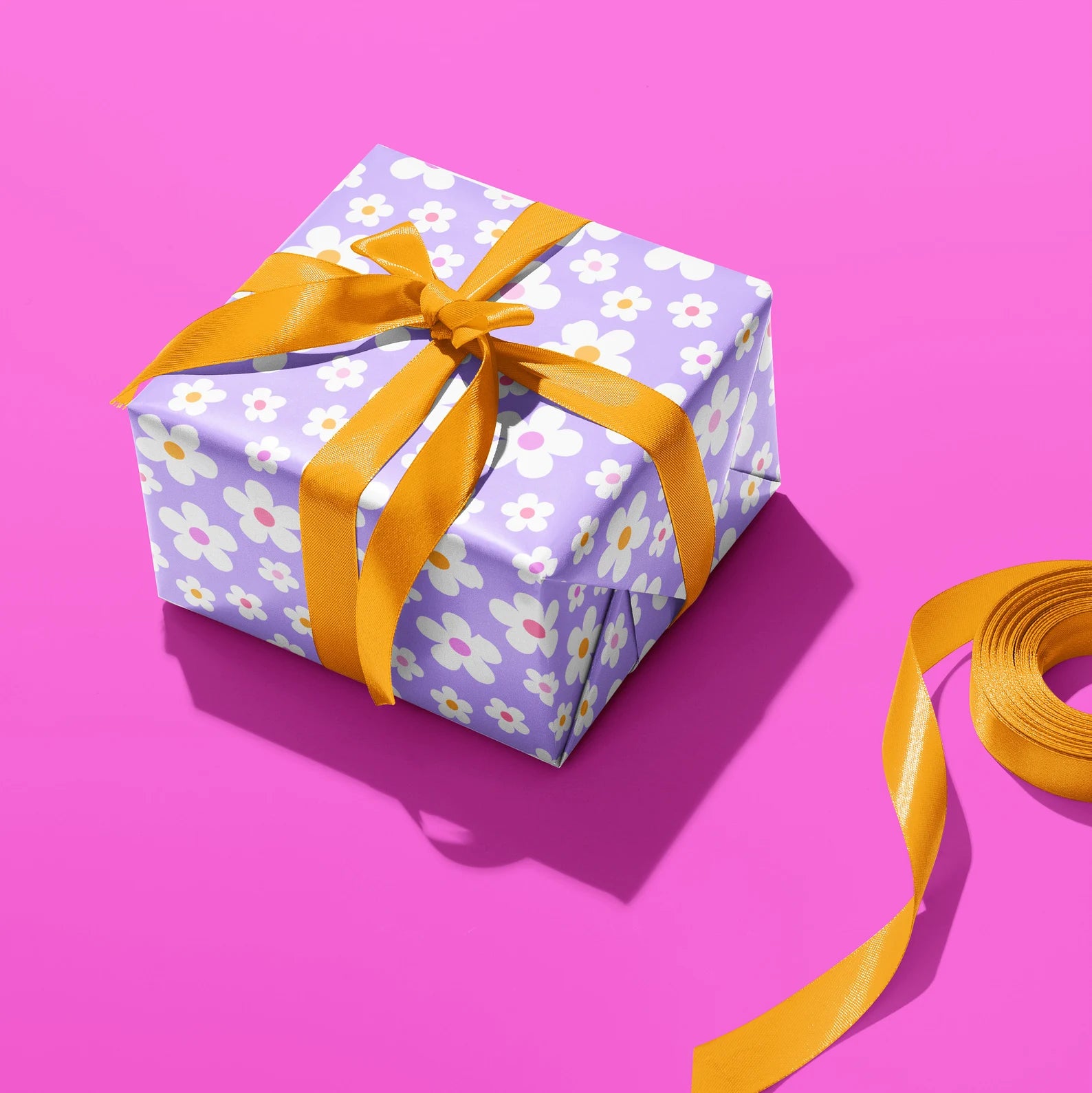 Sprinkle Club - A present wrapped in daisy wrapping paper and tied with an orange ribbon