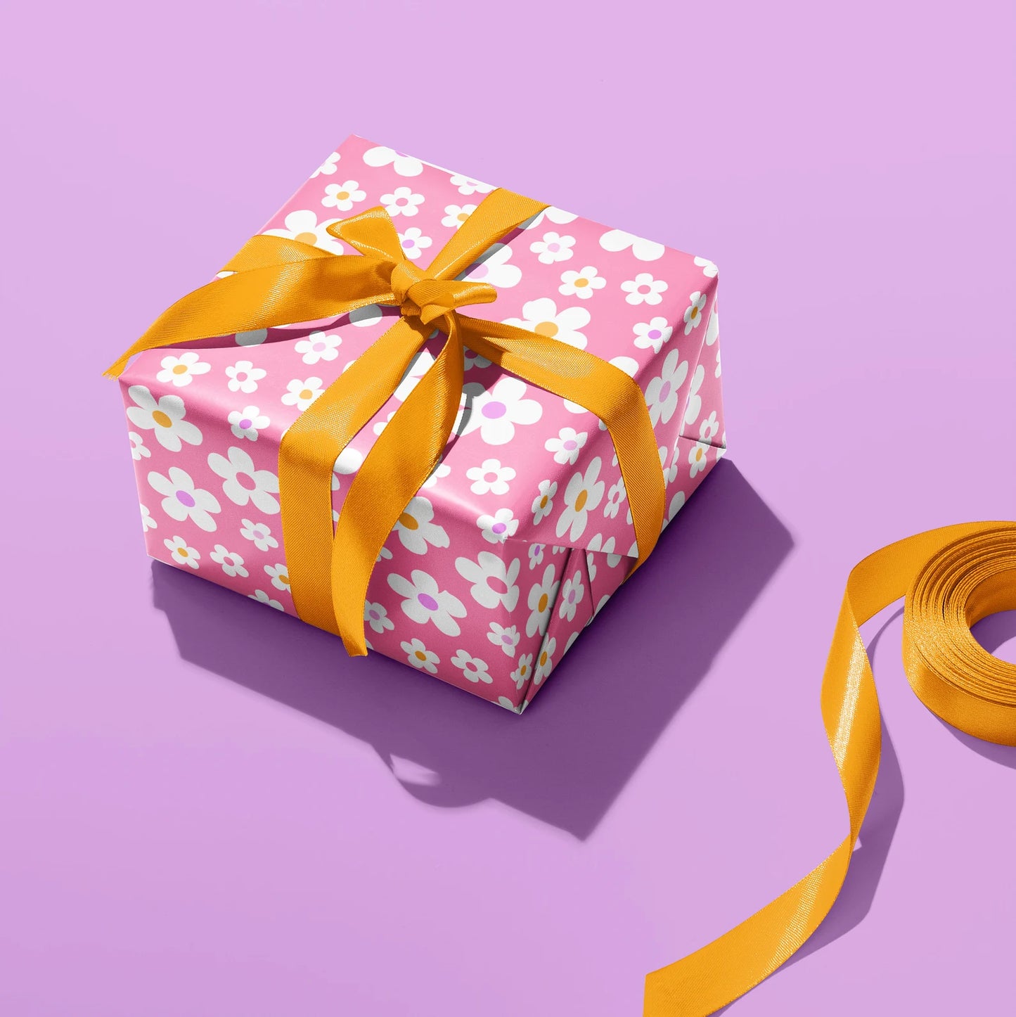 Sprinkle Club - A gift wrapped in pink daisy wrapping paper for a birthday