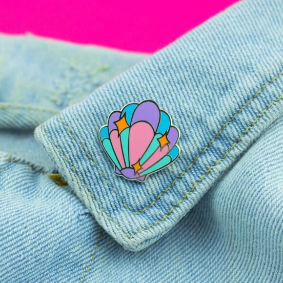 Sprinkle Club - Pastel shell enamel pin decorated on a denim jacket